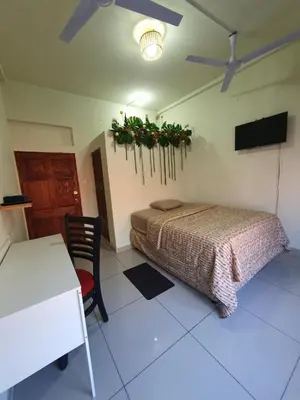 a bedroom with a bed and a table and a desk at Zacatecoluca House in Zacatecoluca
