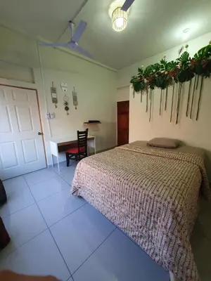 a bedroom with a bed and a desk and a table at Zacatecoluca House in Zacatecoluca
