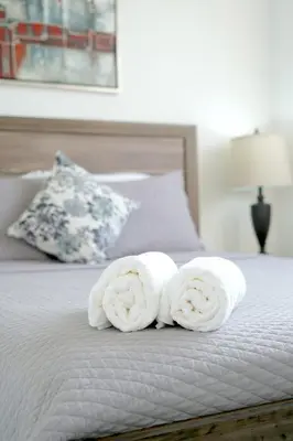 two rolls of towels sitting on top of a bed at Modern Retreat in San Miguel