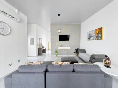 a living room with a couch and a tv at Modern Retreat in San Miguel