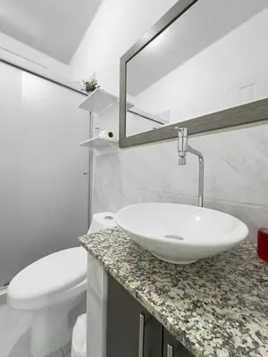 a bathroom with a white sink and a toilet at Modern Retreat in San Miguel