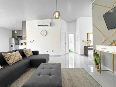 a living room with a couch and a tv at Modern Retreat in San Miguel