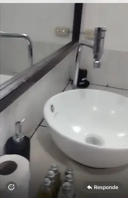 a bathroom with a white sink and a toilet at May Apartamento in San Salvador