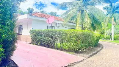 a house with a pink heart sign on a hedge at Golden Sunset House in Acajutla