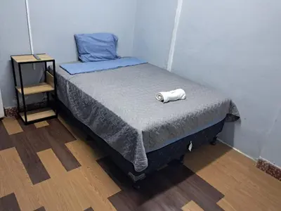 a small bedroom with a bed with a towel on it at Hostal Venezuela in San Salvador