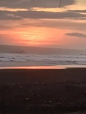 a sunset on a beach with the ocean at Rancho Joya Del Mar in Sonsonate