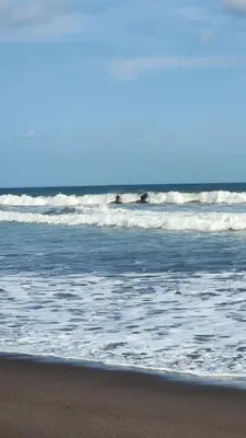 a person standing on the beach near the ocean at Rancho Joya Del Mar in Sonsonate