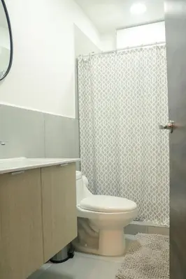 a bathroom with a toilet and a shower at Park Tower 804 in Nuevo Cuscatlán