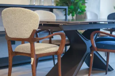 a wooden chair sitting at a black table at Park Tower 804 in Nuevo Cuscatlán