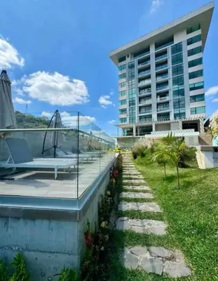 a view of the building from the garden at Park Tower 804 in Nuevo Cuscatlán