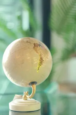 a small globe on top of a table at Park Tower 804 in Nuevo Cuscatlán
