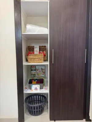a closet with a brown door and some food items at La Bella Suite in San Salvador