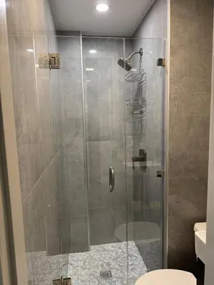 a shower with a glass door in a bathroom at La Bella Suite in San Salvador