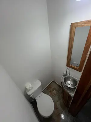 a small bathroom with a toilet and a sink at Hotel Vista Hermosa Suchitoto in Suchitoto