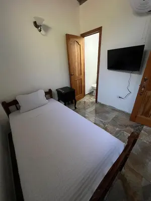 a bedroom with a bed and a flat screen tv at Hotel Vista Hermosa Suchitoto in Suchitoto