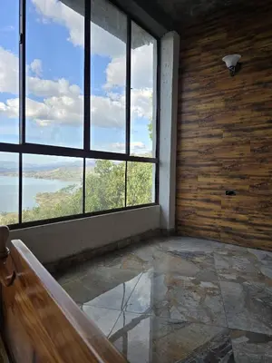an empty room with large windows in a building at Hotel Vista Hermosa Suchitoto in Suchitoto