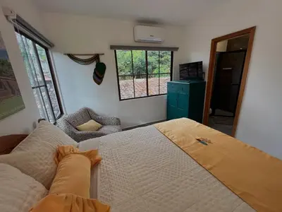 a bedroom with a large bed and a window at Hotel Vista Hermosa Suchitoto in Suchitoto