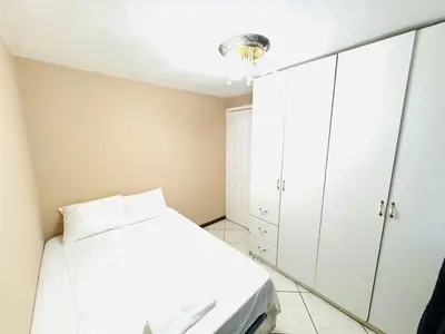 a bedroom with a white bed and a mirror at Apartamento completo Ideal para descansar en familia en San Salvador in San Salvador