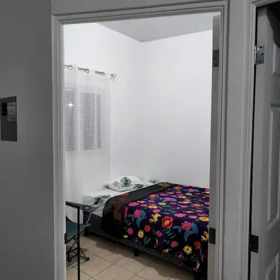 a bedroom with a bed in a room at Santa Ana Maquilishuat in Santa Ana