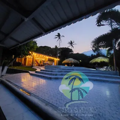 a swimming pool with a resort logo on it at Quinta Sandoval Lago de Coatepeque in Santa Ana