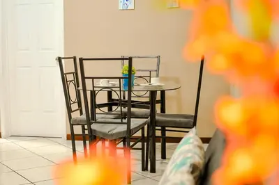 a dining room table and chairs with a vase on it at Ideal para descansar Apartamento equipado en San Salvador in Mexicanos