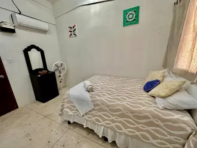 a bedroom with a bed and a fan at Rancho El Angel, La Costa Del Sol in San Luis La Herradura