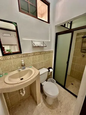 a bathroom with a sink and a toilet and a mirror at Rancho El Angel, La Costa Del Sol in San Luis La Herradura