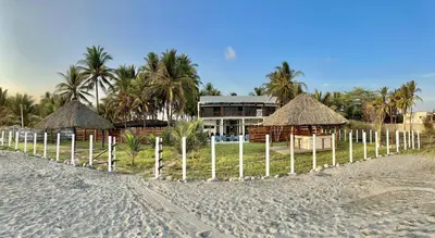 a resort on the beach with a fence in front of it at Rancho El Angel, La Costa Del Sol in San Luis La Herradura