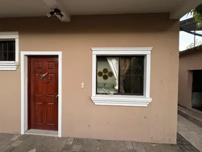 a house with a door and a window at Macaw Stay Room in Sonzacate