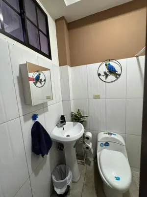 a bathroom with a toilet and a sink at Macaw Stay Room in Sonzacate