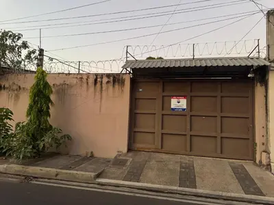 a garage door with a sign on top of it at Macaw Stay Room in Sonzacate