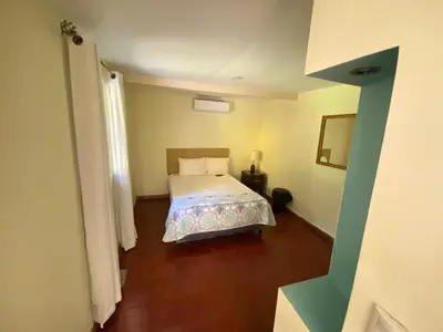 a bedroom with a bed in a room at Hotel y Restaurante Ocean Corner in El Zonte