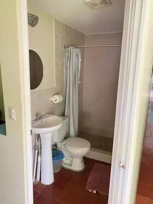 a bathroom with a toilet and a sink at Hotel y Restaurante Ocean Corner in El Zonte