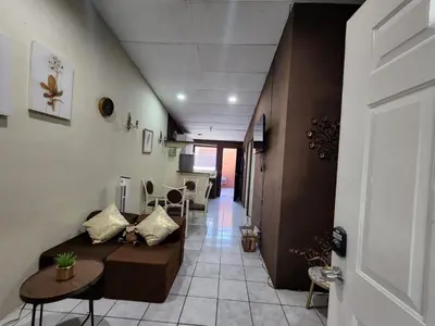 a living room with a couch and a table at Casa Dorada in Santa Ana