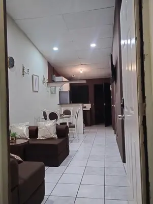 a living room with couches and a dining room at Casa Dorada in Santa Ana