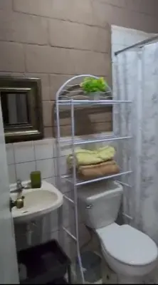 a bathroom with a toilet and a sink and a shower at Casa Dorada in Santa Ana
