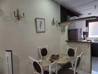 a dining room with a table and chairs in a kitchen at Casa Dorada in Santa Ana