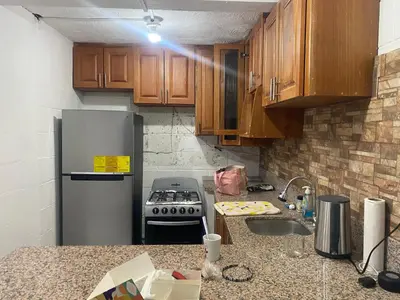 a kitchen with a refrigerator and a sink at Hostal Maracay San Salvador in San Salvador