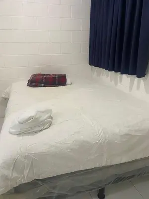 a bed with a white shirt on top of it at Hostal Maracay San Salvador in San Salvador