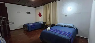 a room with two beds in a room at Antique Luna in Santa Ana