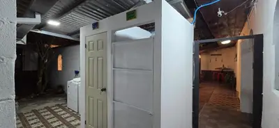 an open door in a room with a kitchen at Antique Luna in Santa Ana