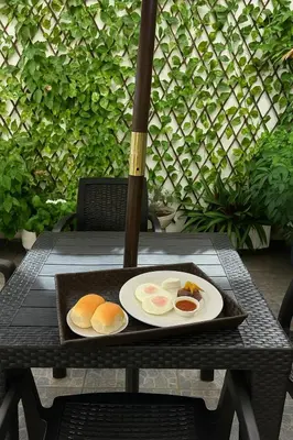 a plate of eggs on a table with an umbrella at Hotel Manantiales El Salvador in San Salvador