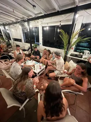 a group of people sitting in chairs in a room at Karma Muse Hotel in La Libertad