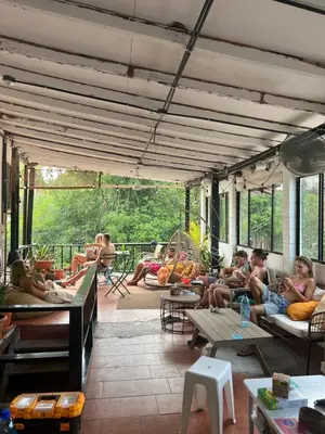 a group of people sitting on a patio at Karma Muse Hotel in La Libertad