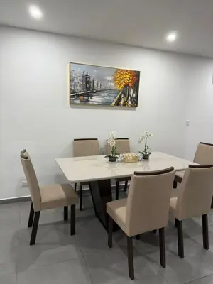 a dining room with a white table and chairs at Paradise Apartment at Gallerias Escalon in Colonia Escalón