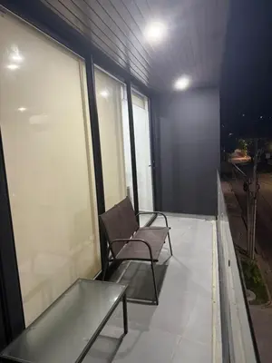 a balcony with a chair and a glass table at Paradise Apartment at Gallerias Escalon in Colonia Escalón