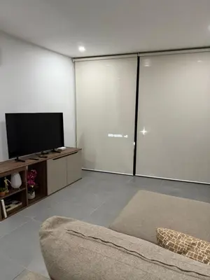 a living room with a flat screen tv and a couch at Paradise Apartment at Gallerias Escalon in Colonia Escalón