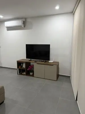 a living room with a flat screen tv on a table at Paradise Apartment at Gallerias Escalon in Colonia Escalón