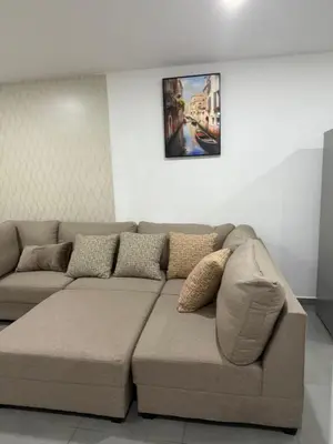 a couch in a living room with a picture on the wall at Paradise Apartment at Gallerias Escalon in Colonia Escalón