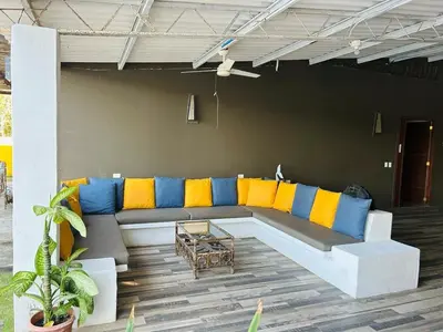 a couch with colorful pillows on a patio at Estero View Beach House in Barra de Santiago